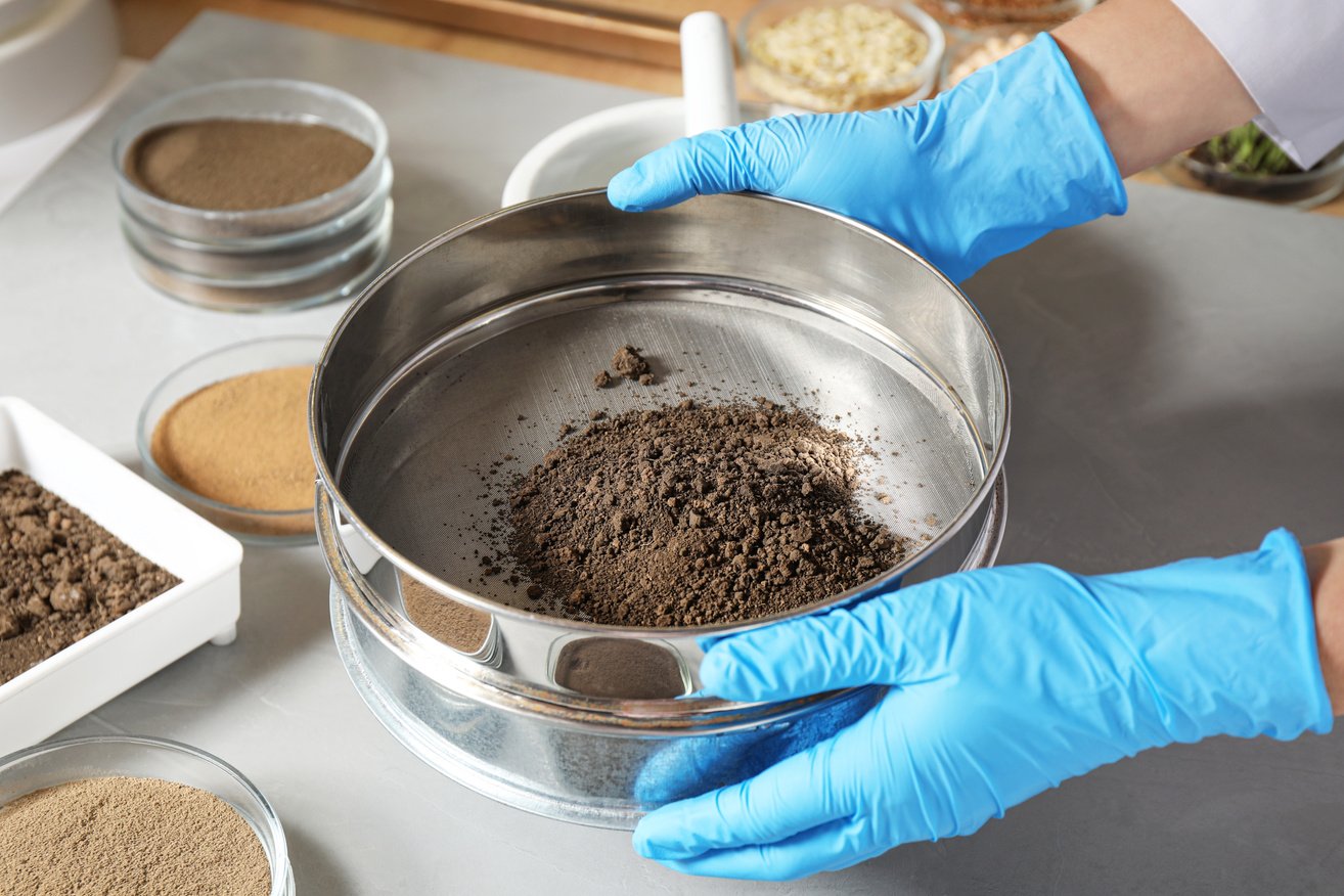 Scientist Pulverizing and Sieving Soil Samples at Table, Closeup. Laboratory Analysis